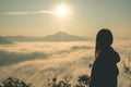 Woman with Sea Fog with sunrise covers the area on the top of hill Doi Phu Thok, Chiang Khan, Loei, Thailand Royalty Free Stock Photo