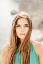 Woman sea green dress. Portrait of a happy woman with long hair in a long mint dress posing on a beach with calm sea Royalty Free Stock Photo