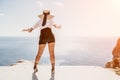 Woman sea hat. Business woman in yellow hat freelancer working over blue sea beach. Girl relieves stress from work Royalty Free Stock Photo