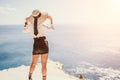 Woman sea hat. Business woman in yellow hat freelancer working over blue sea beach. Girl relieves stress from work Royalty Free Stock Photo