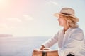 Woman sea laptop. Business woman in yellow hat freelancer with laptop working over blue sea beach. Girl relieves stress Royalty Free Stock Photo