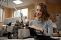 A woman seamstress works on a sewing machine in a workshop