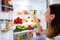 Woman Searching For Food In The Fridge Royalty Free Stock Photo