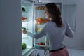 Woman Searching For Food In The Fridge Royalty Free Stock Photo