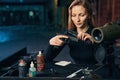 Woman seated at the table assembling a handgun