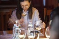 Woman Sitting at Table With Wine Glasses and Semmling it