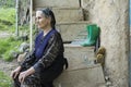 Woman seated on wooden steps and thinking