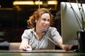 Young woman sitting at her desk working and answering a phone call Royalty Free Stock Photo