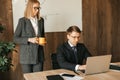 Woman secretary brought a cup of coffee to her boss, office teamwork. Colleague support.