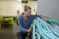 woman securing bundle rope in fish factory