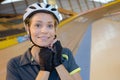 Woman securing strap riding helmet