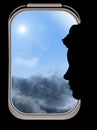 A woman is seen in silhouette against the window of her plane. Royalty Free Stock Photo