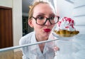 Woman sees the sweet cake in fridge Royalty Free Stock Photo