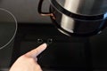 Woman touching electric hob