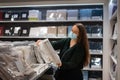 Woman selecting blanket in shop