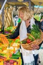 Woman selecting a bunch of fresh carrots Royalty Free Stock Photo