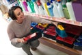 Woman selecting cleaning brush in store Royalty Free Stock Photo