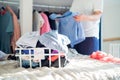 A Woman selecting clothes from her wardrobe for donating to a Charity shop. Decluttering Clothes, Sorting, And Cleaning Royalty Free Stock Photo