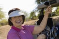 Woman selecting golf club from golf cart