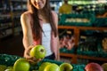 Woman selecting a green apple in organic section Royalty Free Stock Photo