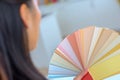 Woman selecting home interior paint color from swatch catalog Royalty Free Stock Photo