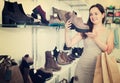 Woman selecting loafers in footgear center