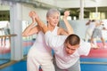 Woman self defense training gym learning to do painful grip Royalty Free Stock Photo