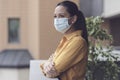 Woman relaxing on the balcony and wearing a face mask Royalty Free Stock Photo