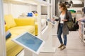 Woman with self-service device in the store