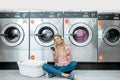 Woman in the self-service laundry Royalty Free Stock Photo