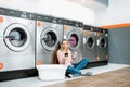 Woman in the self-service laundry Royalty Free Stock Photo