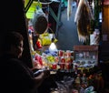 Woman sellig candies in her store ouside the street