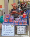 Woman is selling birds at the petshop in Pattaya, Thailand