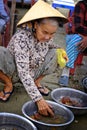 Woman selling fish on the beach.