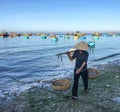 A woman selling fishes on the beach in Phan Rang, Vietnam