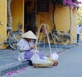 A woman selling foods on street in Hoian, Vietnam