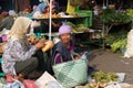 Woman selling fruit and vegetables in wet market near Borobudur temple, Java, Indonesia