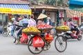 Woman is selling fruits from bicycle on the street. Royalty Free Stock Photo