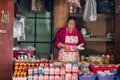 Woman is selling goods at the market.