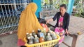 A woman selling jamu, a health drink made from herbal concoctions