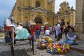 Woman selling selling colorful rubber balls in a street of the old city of Antigua with the San Pedro Hospital on the background, Royalty Free Stock Photo