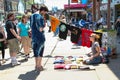 Woman selling shirt on the side walk of Kensington Market