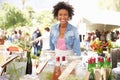 Woman Selling Soft Drinks At Farmers Market Stall