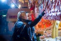 Woman selling traditional sweets in stall in the Christmas market in Vienna. on December in Vienna.