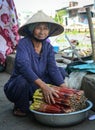 A woman selling vegetables at market in Soc Trang, Vietnam