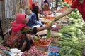 A woman is selling vegetables at a street market in Labuanbajo Royalty Free Stock Photo