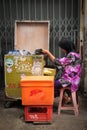 Woman selling water in Medan, Indonesia