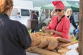 A woman sells baked goods from a tray at the fair of the Karatag music festival. Krasnoyarsk region. Russia Royalty Free Stock Photo