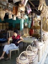 A woman sells different kinds of handicraft and home products