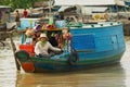 Woman sells goods from the boat at the floating market at Tonle Sap lake in Siem Reap, Cambodia. Royalty Free Stock Photo